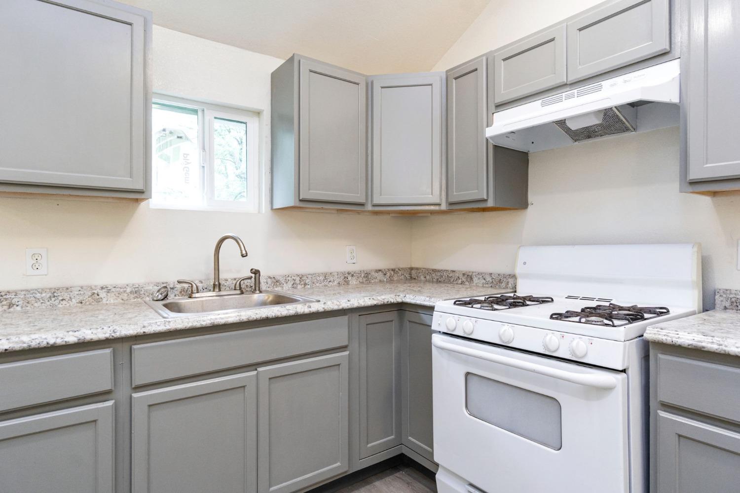 46801 Dunlap Road Miramonte, CA 93641 - Photo 9 of 28 a kitchen with cabinets appliances a sink and a counter top space
