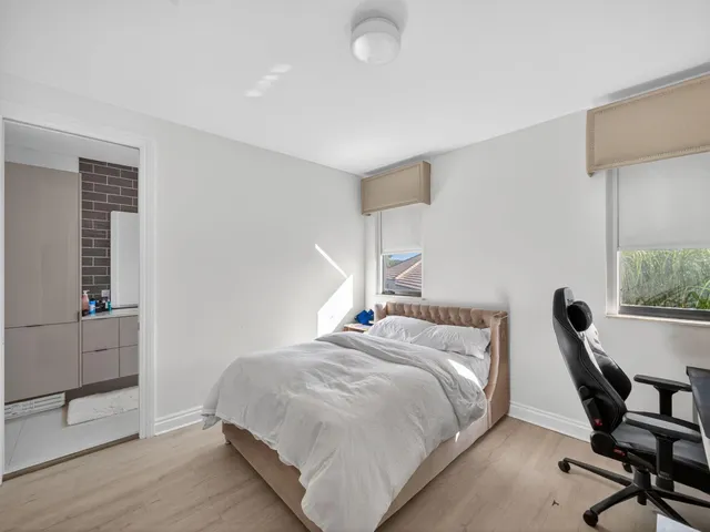 a bedroom with a bed a desk and chair