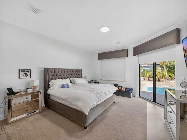 a spacious bedroom with a bed and a cabinets