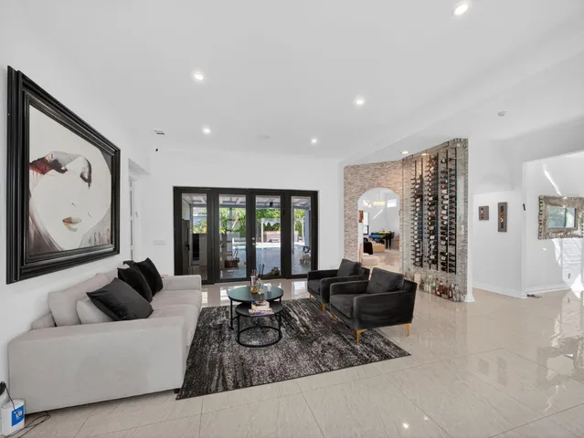 a living room with furniture large window and furniture