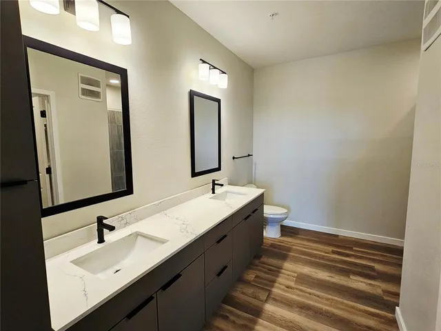 a bathroom with 2 sink and a mirror