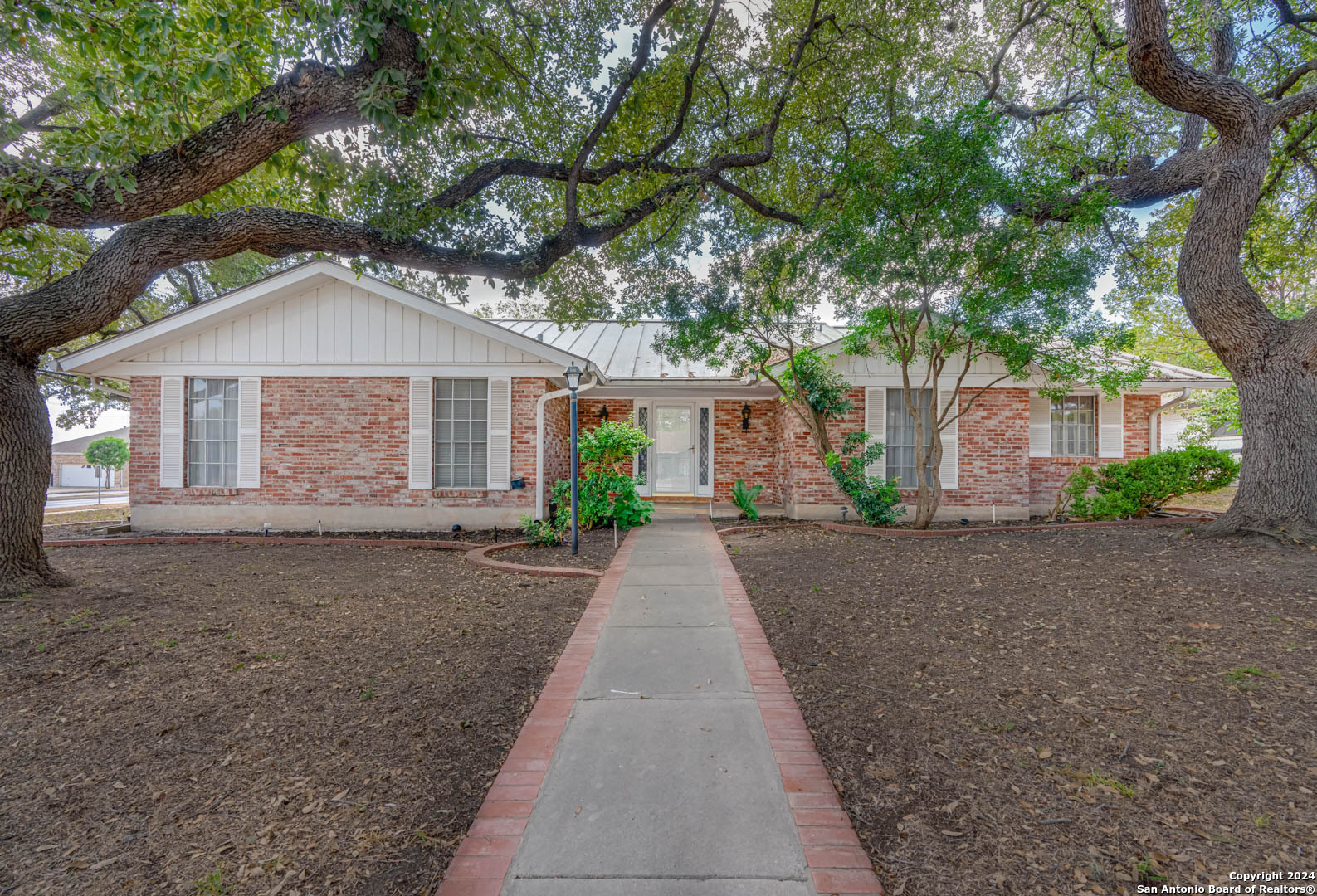 a front view of a house with a yard and a garage
