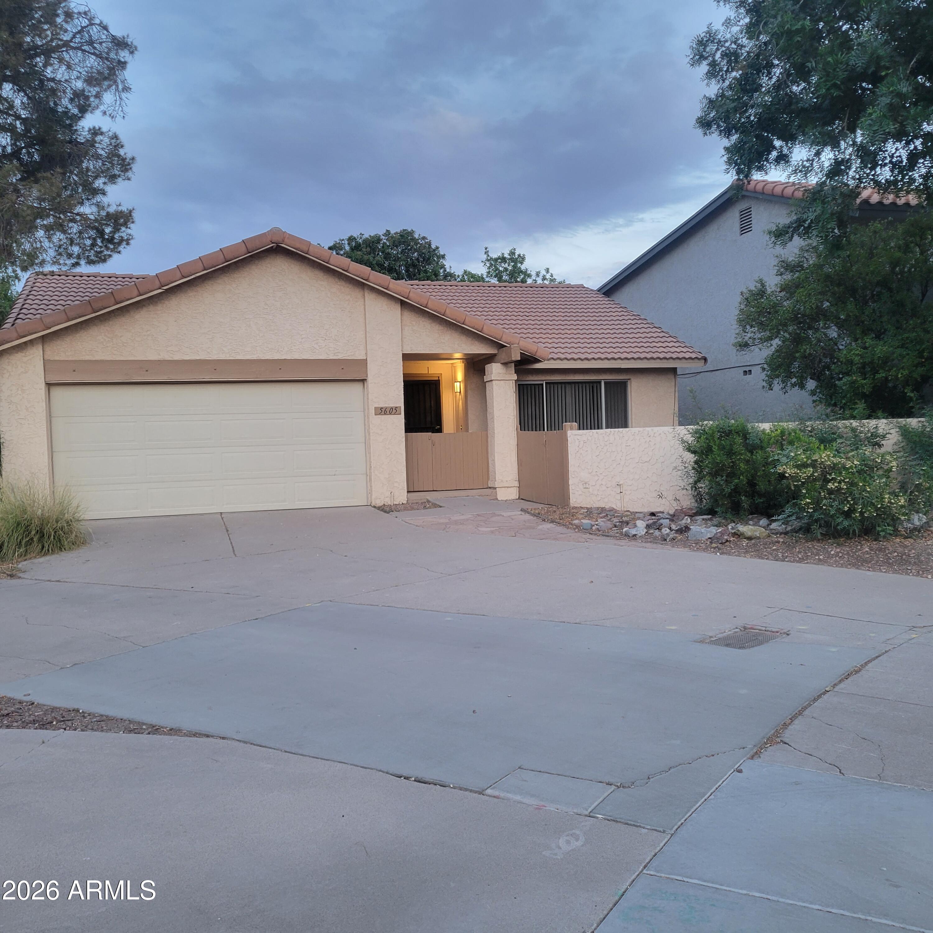 5605 South Spinnaker Road Tempe, AZ 85283 - Photo 1 of 26 a view of garage yard and front view of a house