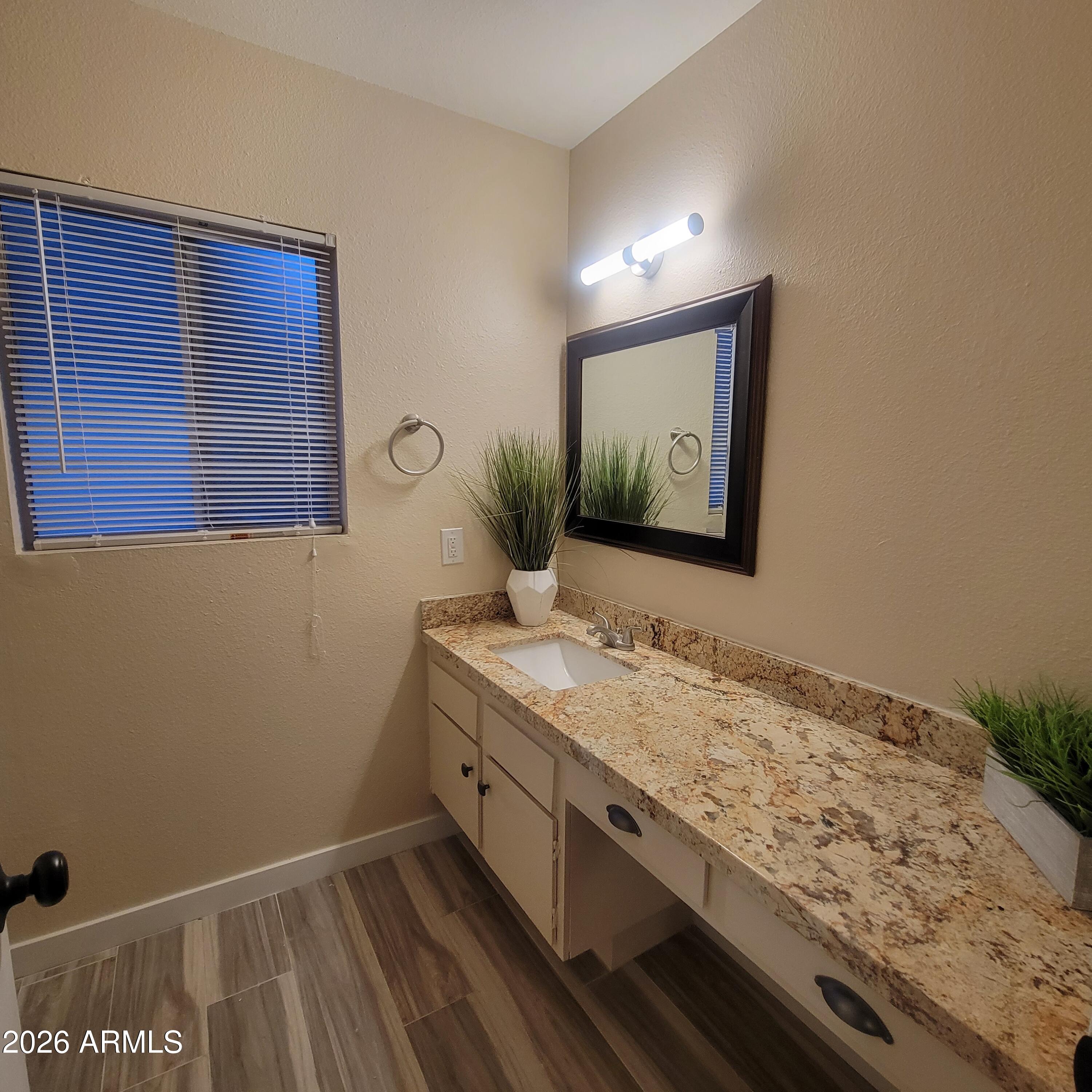 5605 South Spinnaker Road Tempe, AZ 85283 - Photo 12 of 26 a bathroom with a granite countertop sink and a mirror