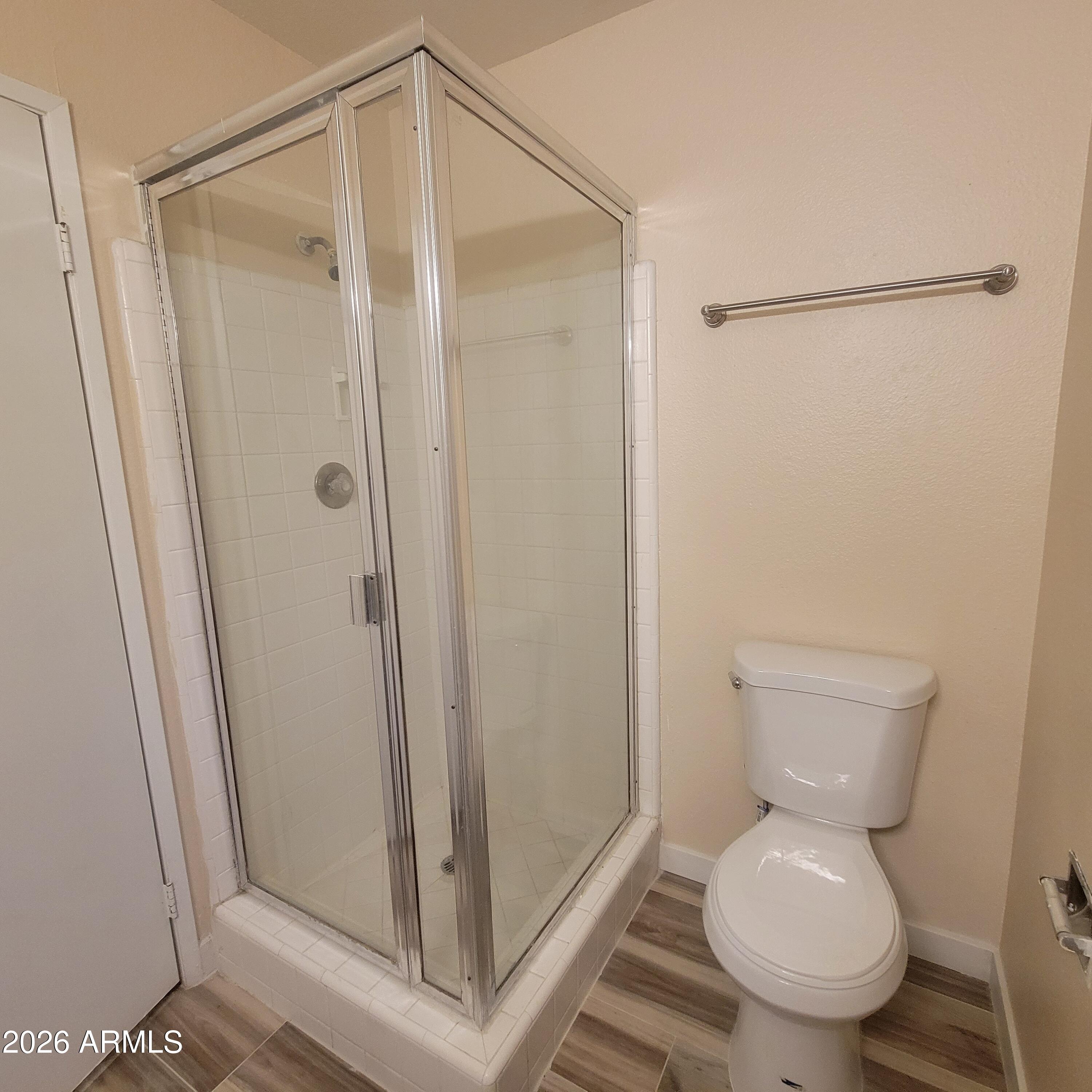 5605 South Spinnaker Road Tempe, AZ 85283 - Photo 13 of 26 a white toilet sitting next to a shower