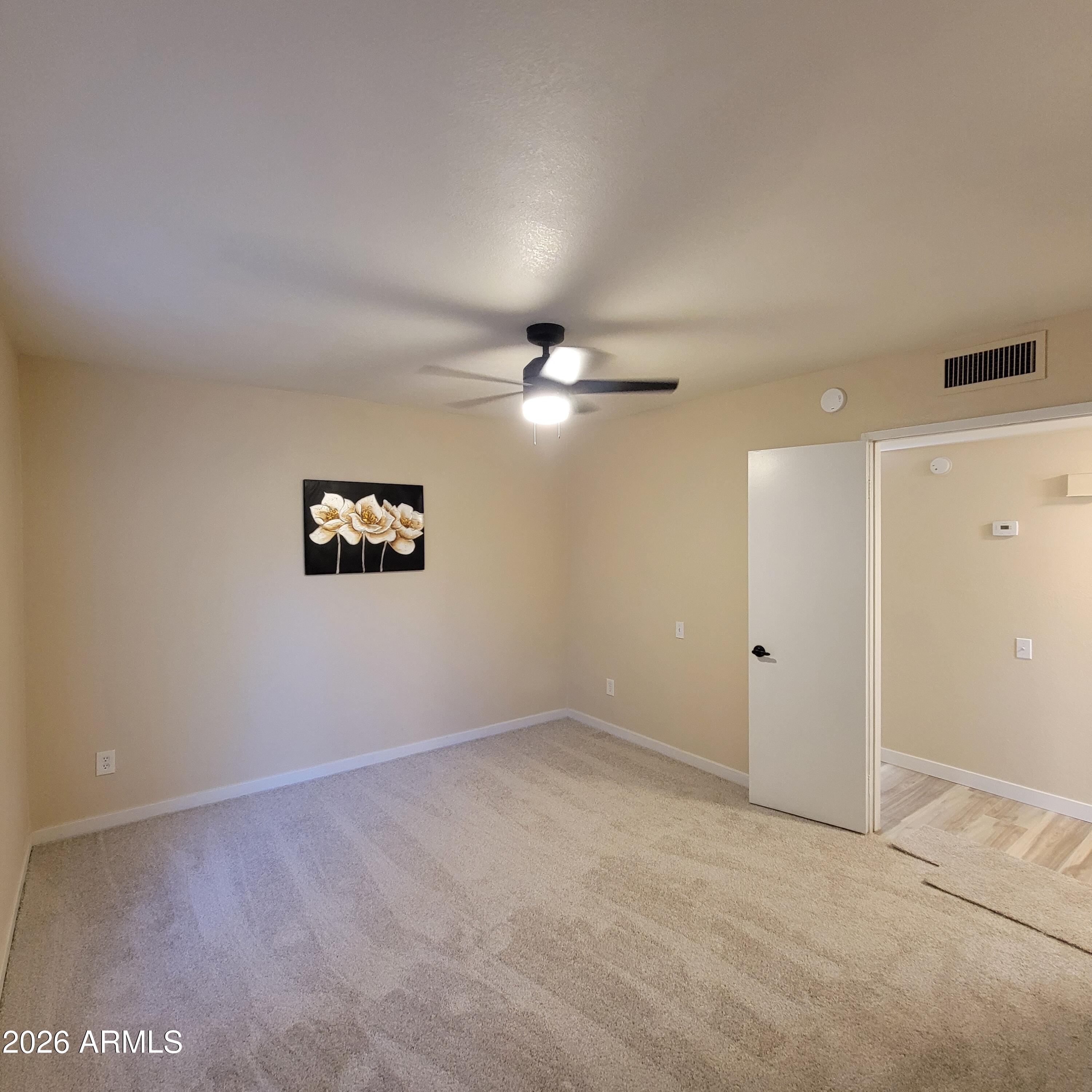 5605 South Spinnaker Road Tempe, AZ 85283 - Photo 15 of 26 an empty room with a fan & a window