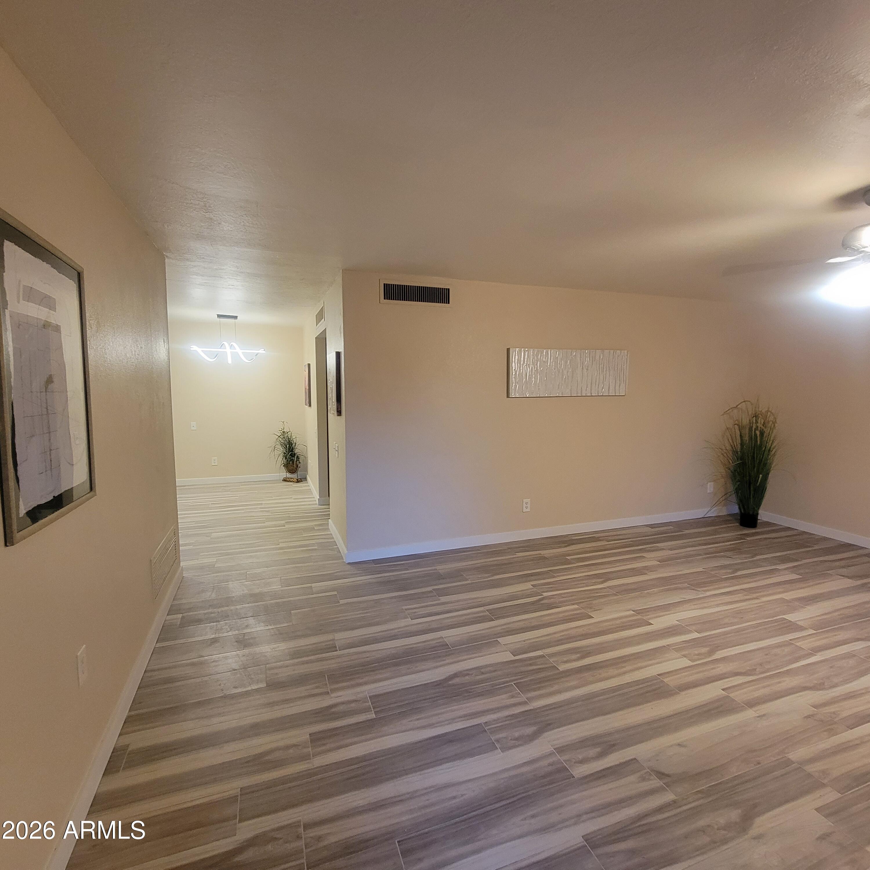 5605 South Spinnaker Road Tempe, AZ 85283 - Photo 2 of 26 a view of empty room with wooden floor
