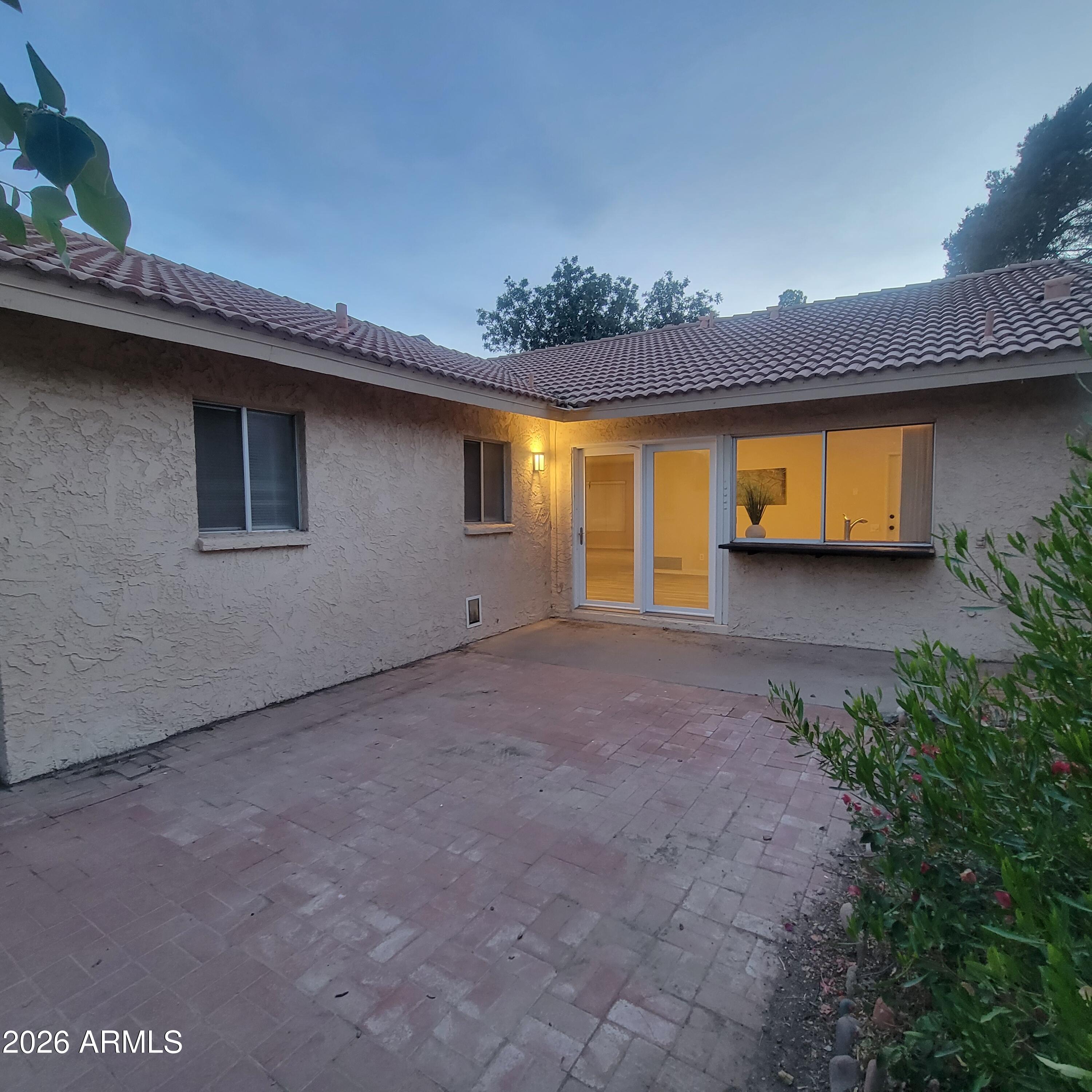 5605 South Spinnaker Road Tempe, AZ 85283 - Photo 23 of 26 a view of a house with a yard and garage