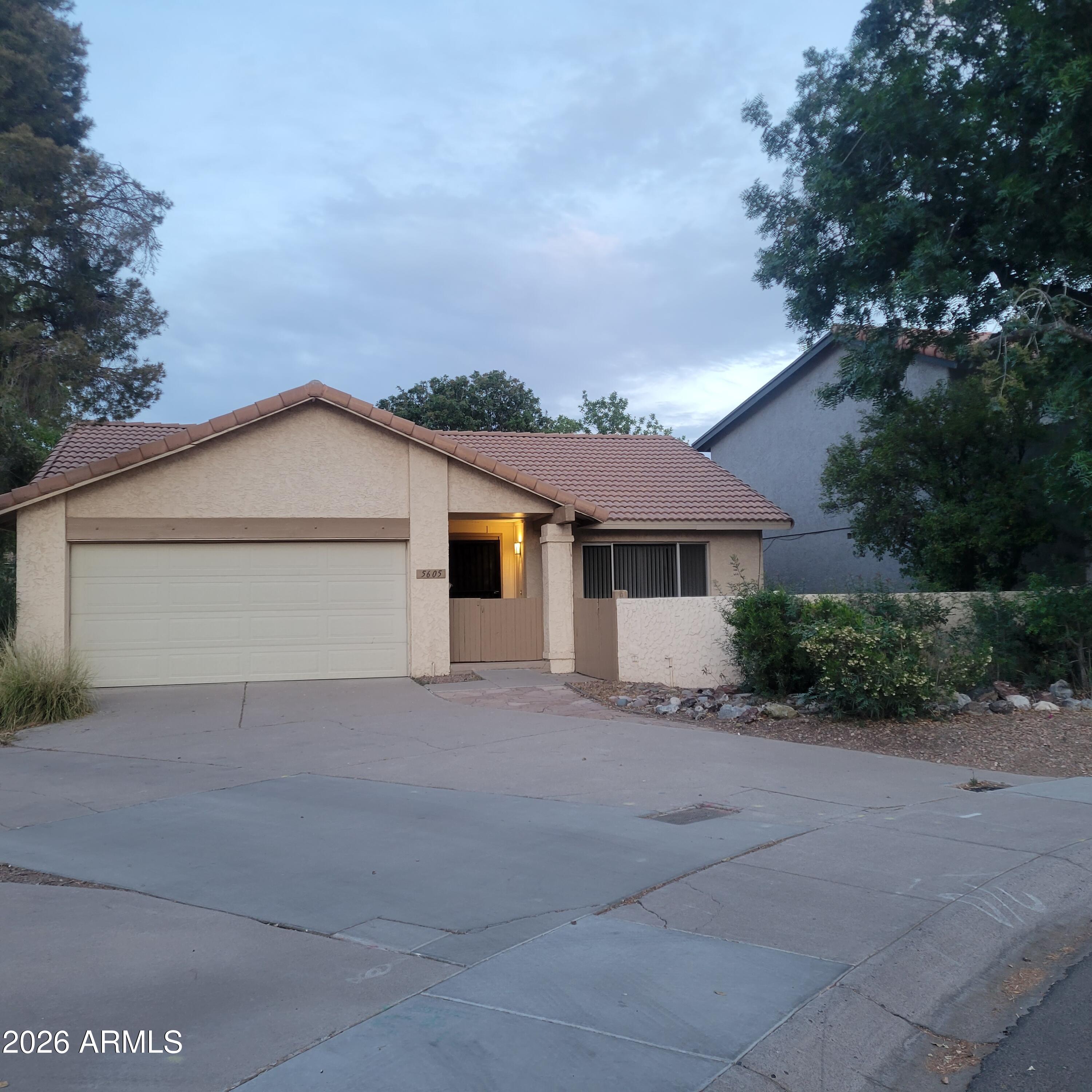 5605 South Spinnaker Road Tempe, AZ 85283 - Photo 25 of 26 a view of a house with a yard and large tree