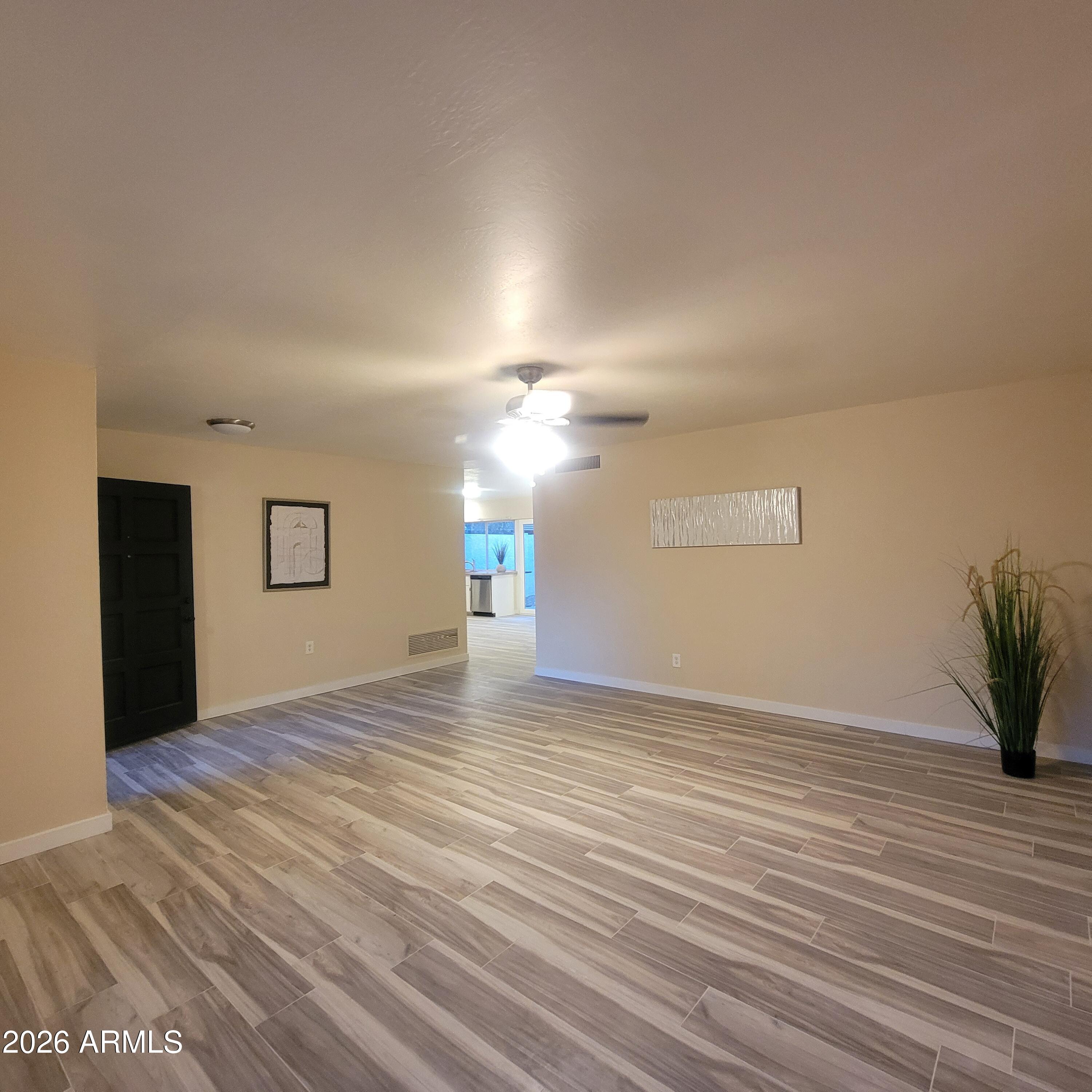 5605 South Spinnaker Road Tempe, AZ 85283 - Photo 3 of 26 a view of empty room with wooden floor