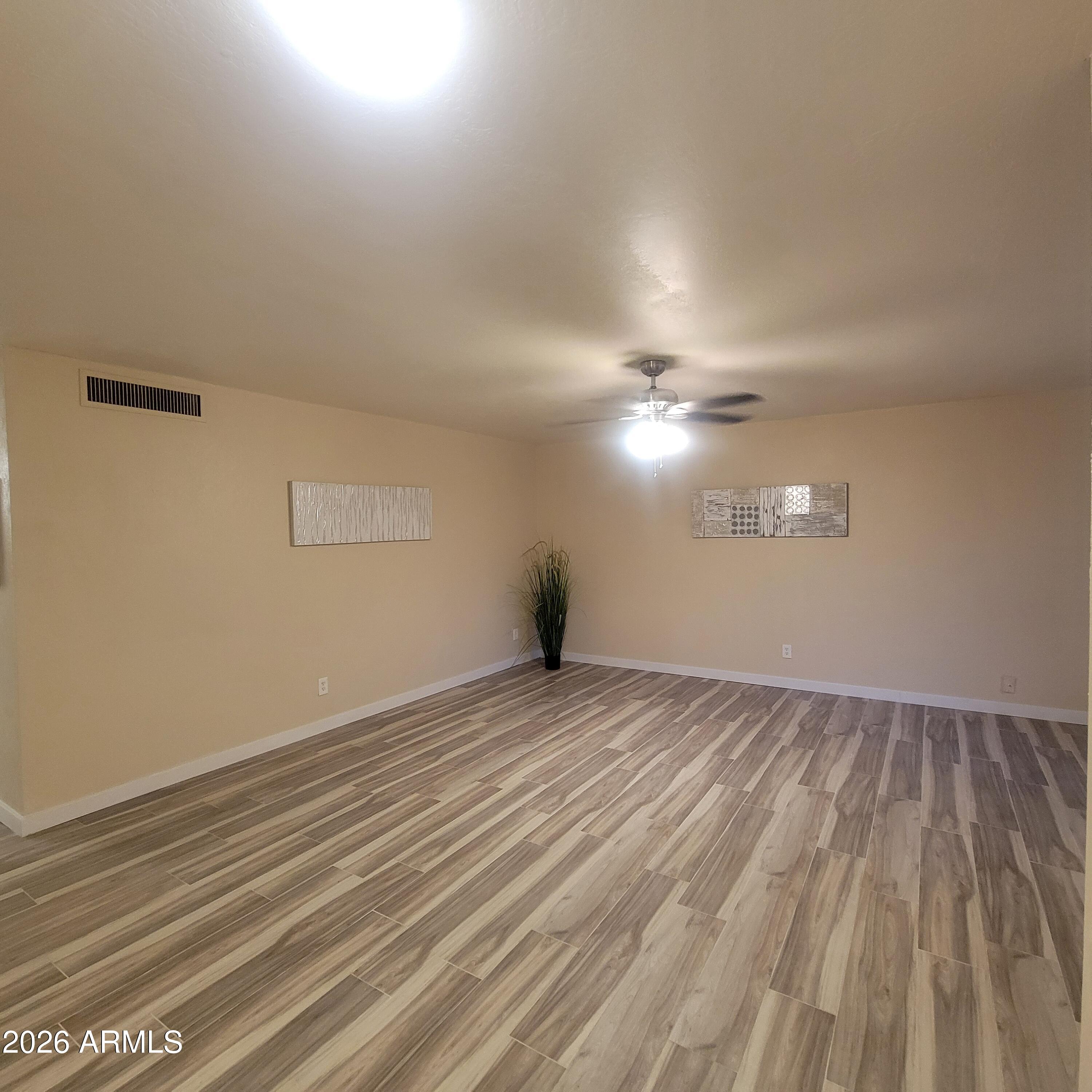 5605 South Spinnaker Road Tempe, AZ 85283 - Photo 4 of 26 a view of empty room with wooden floor