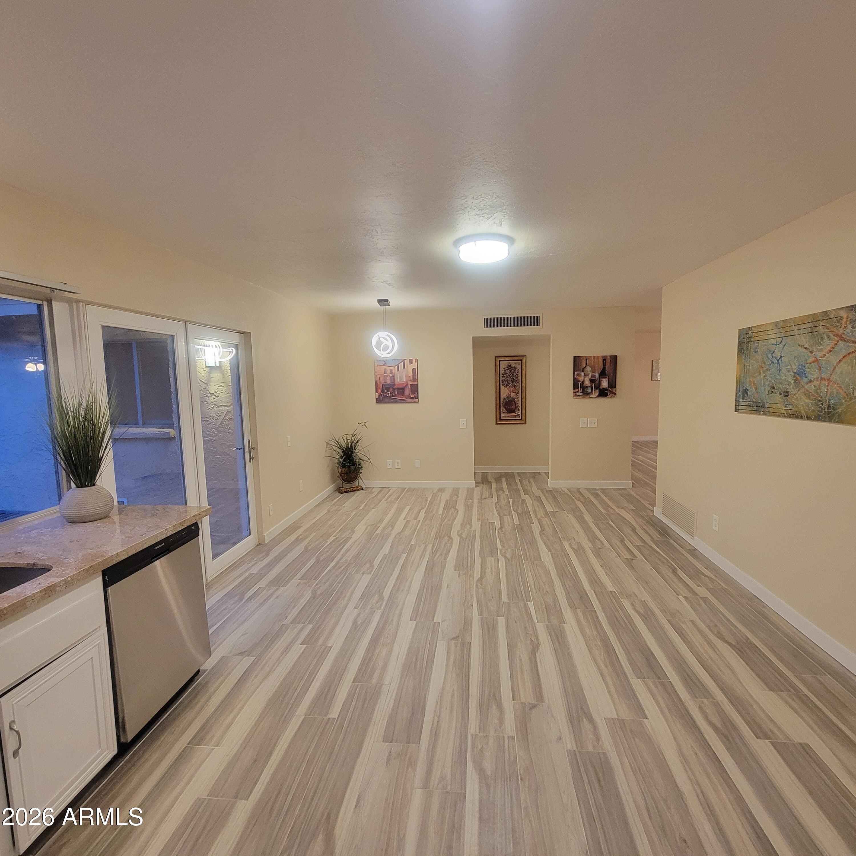 5605 South Spinnaker Road Tempe, AZ 85283 - Photo 7 of 26 a view of a room with wooden floor and furniture