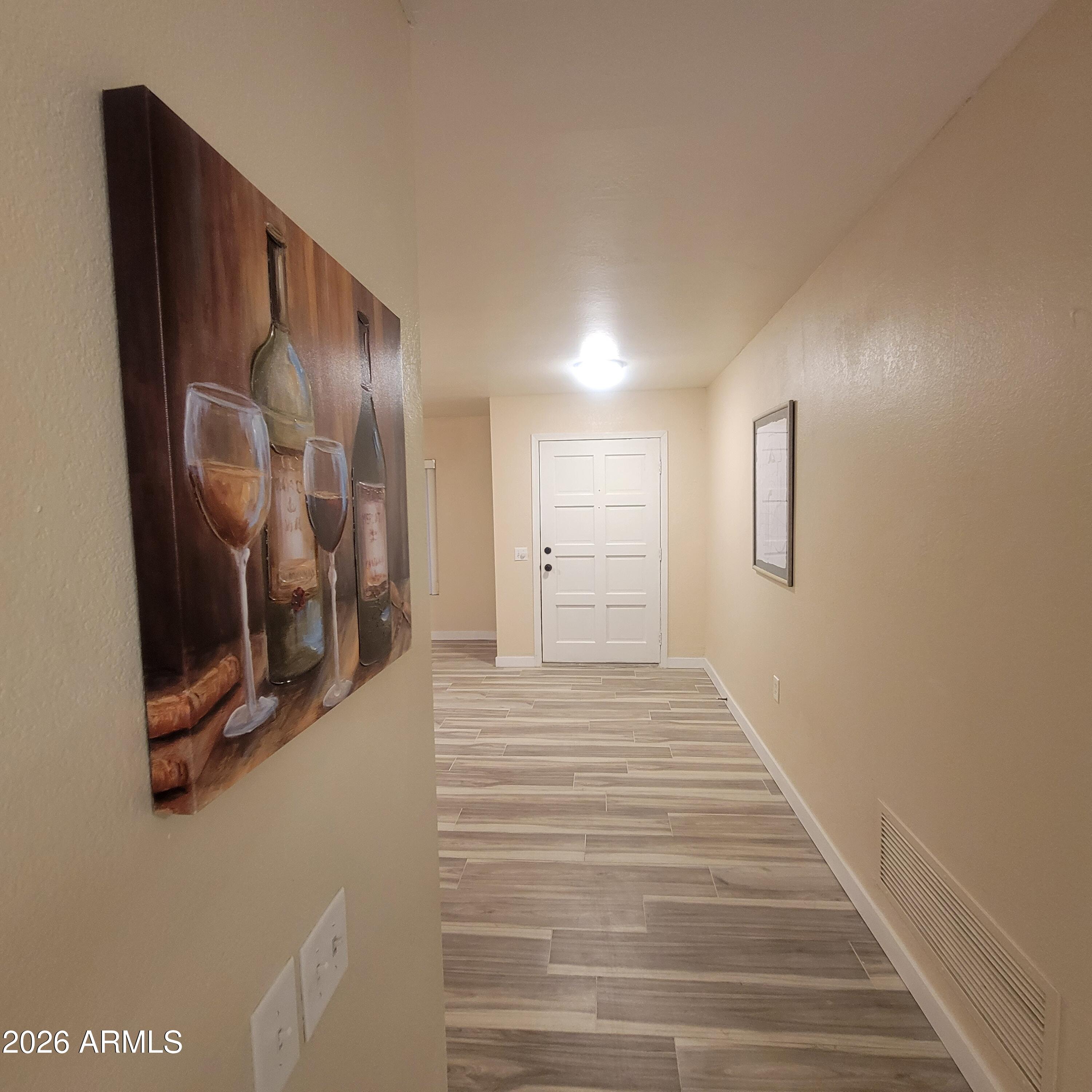 5605 South Spinnaker Road Tempe, AZ 85283 - Photo 8 of 26 a view of a hallway with wooden floor and glass door