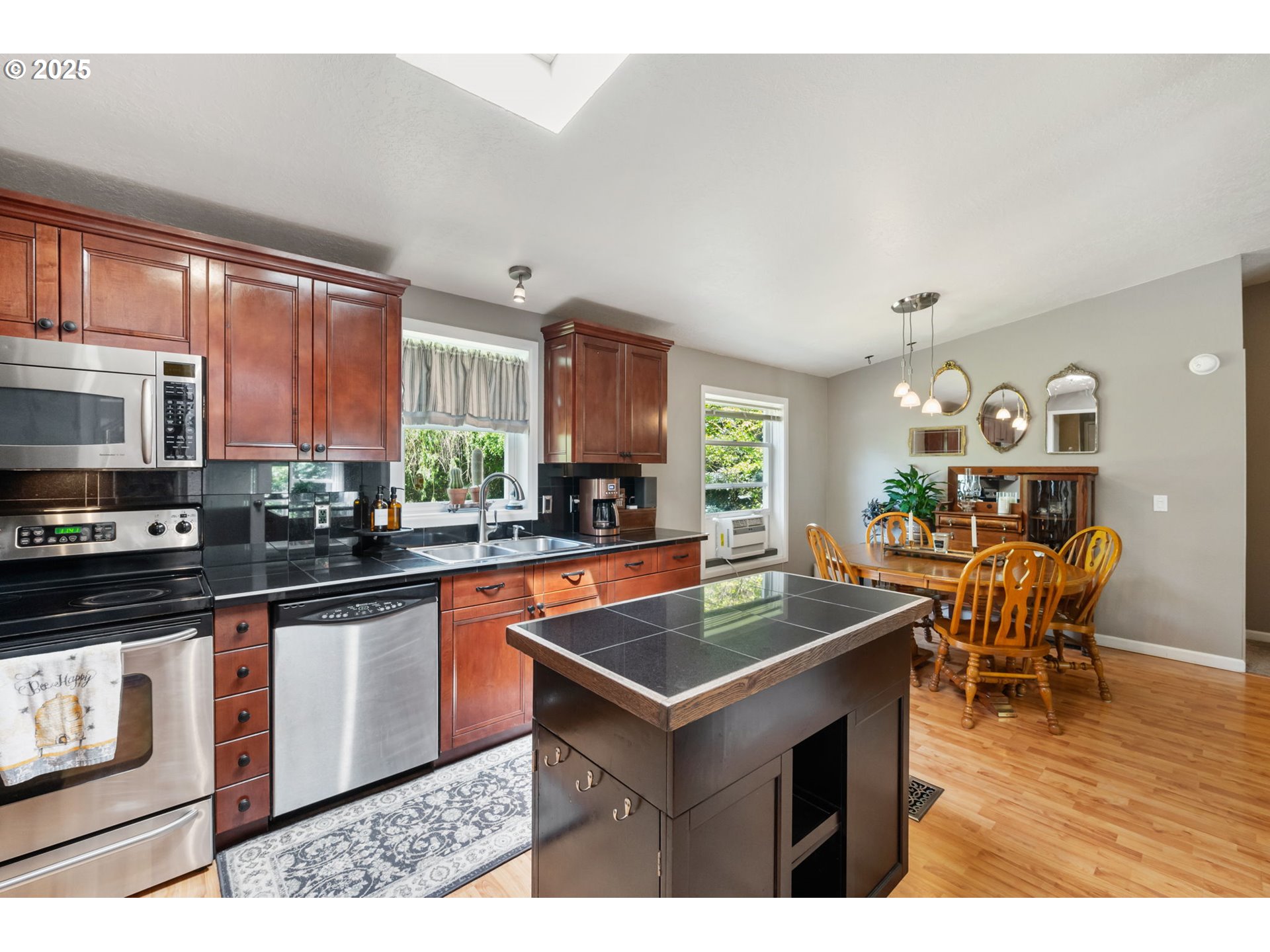 31255 South Kauffman Road Canby, OR 97013 - Photo 13 of 48 a kitchen with stainless steel appliances granite countertop a stove top oven a sink dishwasher and cabinets with wooden floor