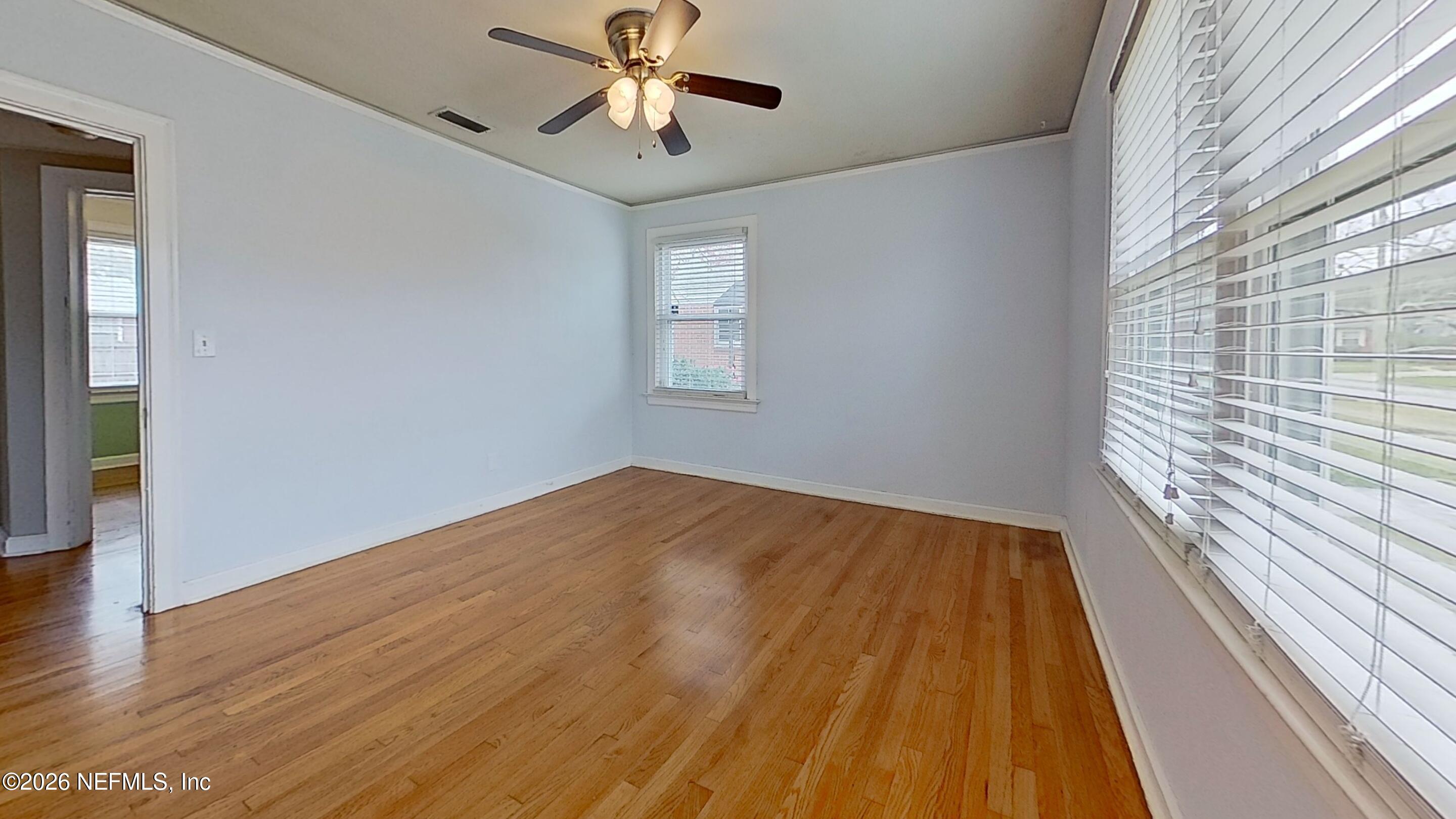 2151 Traymore Road Jacksonville, FL 32207 - Photo 12 of 18 wooden floor in an empty room with a window