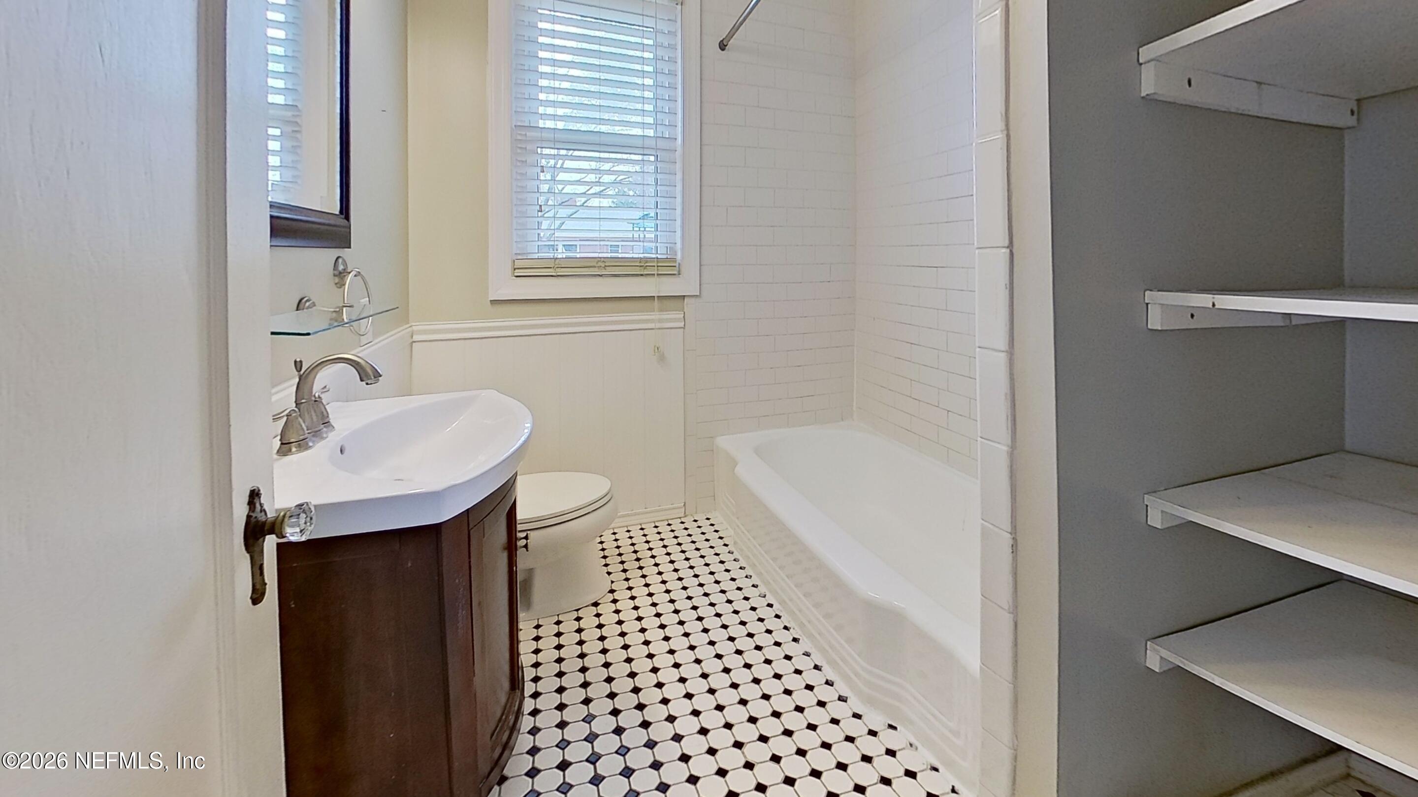 2151 Traymore Road Jacksonville, FL 32207 - Photo 16 of 18 a bathroom with a sink a mirror and a shower