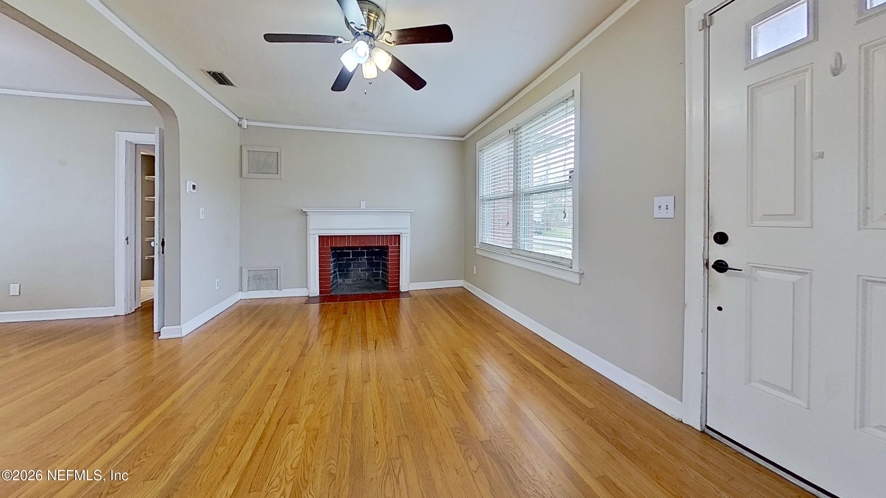 2151 Traymore Road Jacksonville, FL 32207 - Photo 6 of 18 a view of empty room with wooden floor and fan