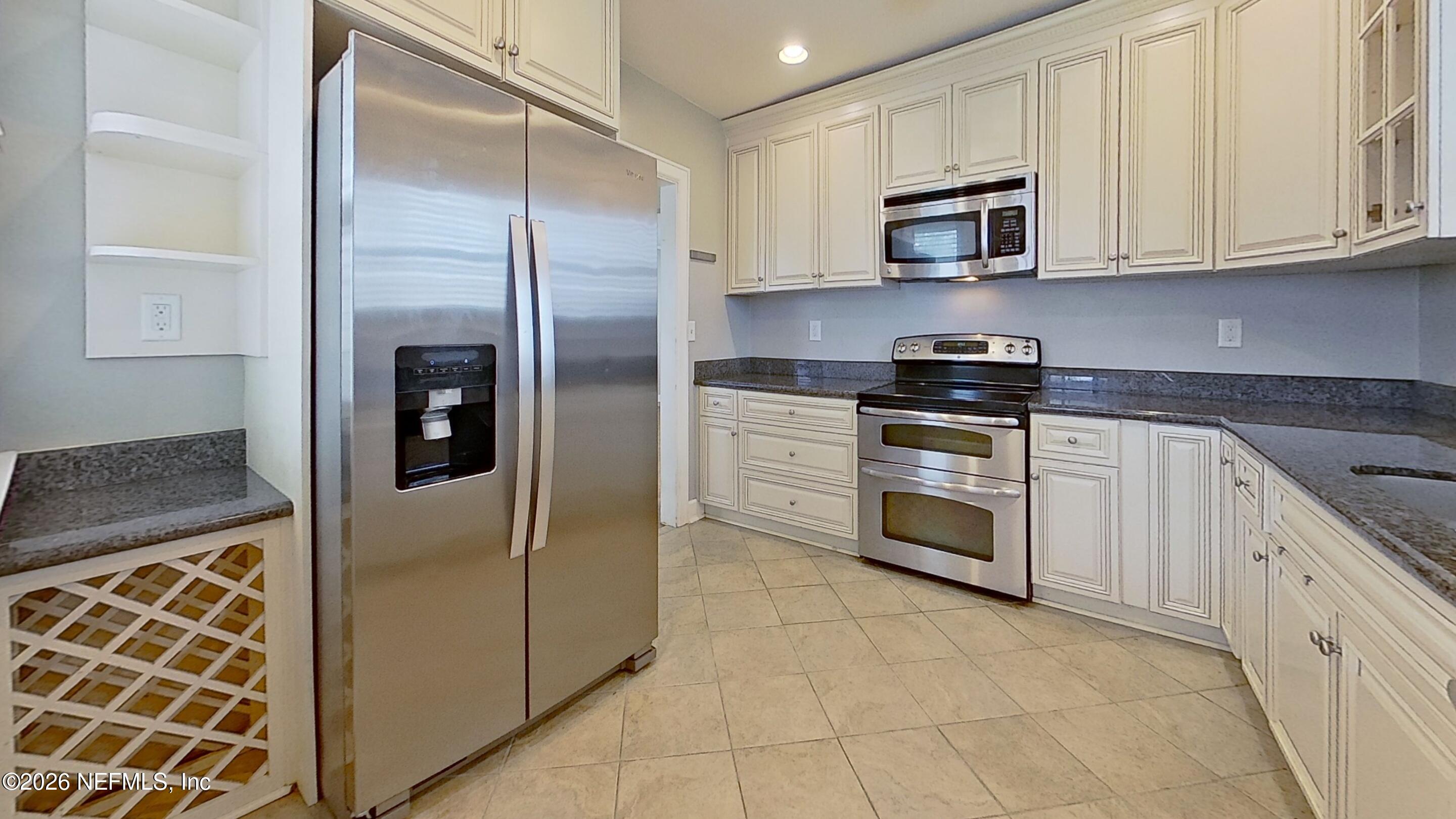 2151 Traymore Road Jacksonville, FL 32207 - Photo 8 of 18 a kitchen with stainless steel appliances granite countertop a stove a sink and a refrigerator