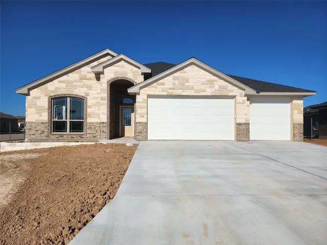 a view of a house with a yard and garage