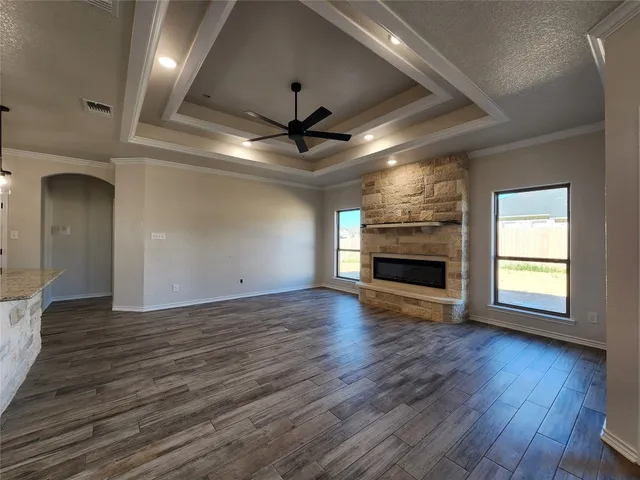 a spacious bathroom with a granite countertop sink a mirror and shower