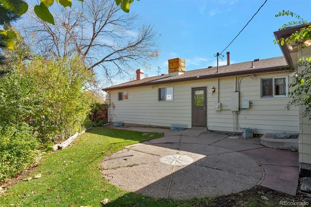 a front view of a house with a yard and trees