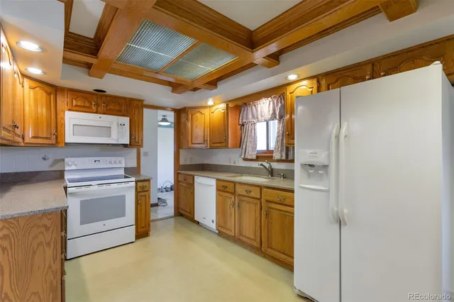 a kitchen with a sink cabinets stainless steel appliances and a counter top space