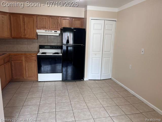 14682 Middle Gibraltar Road, Unit 24 Rockwood, MI 48173 - Photo 7 of 21 Kitchen featuring wood cabinetry, a tiled backsplash, and a white electric range