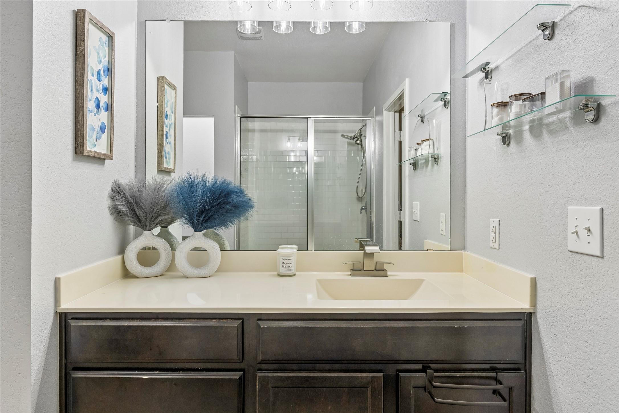 14409 Estuary Road Manor, TX 78653 - Photo 21 of 24 Bathroom vanity with a light-toned countertop, integrated sink, and brushed nickel faucet