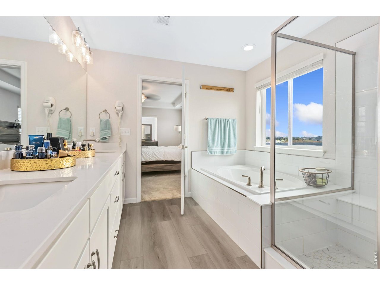 955 Rustling Street Windsor, CO 80550 - Photo 14 of 34 a spacious bathroom with a sink a mirror and a bathtub
