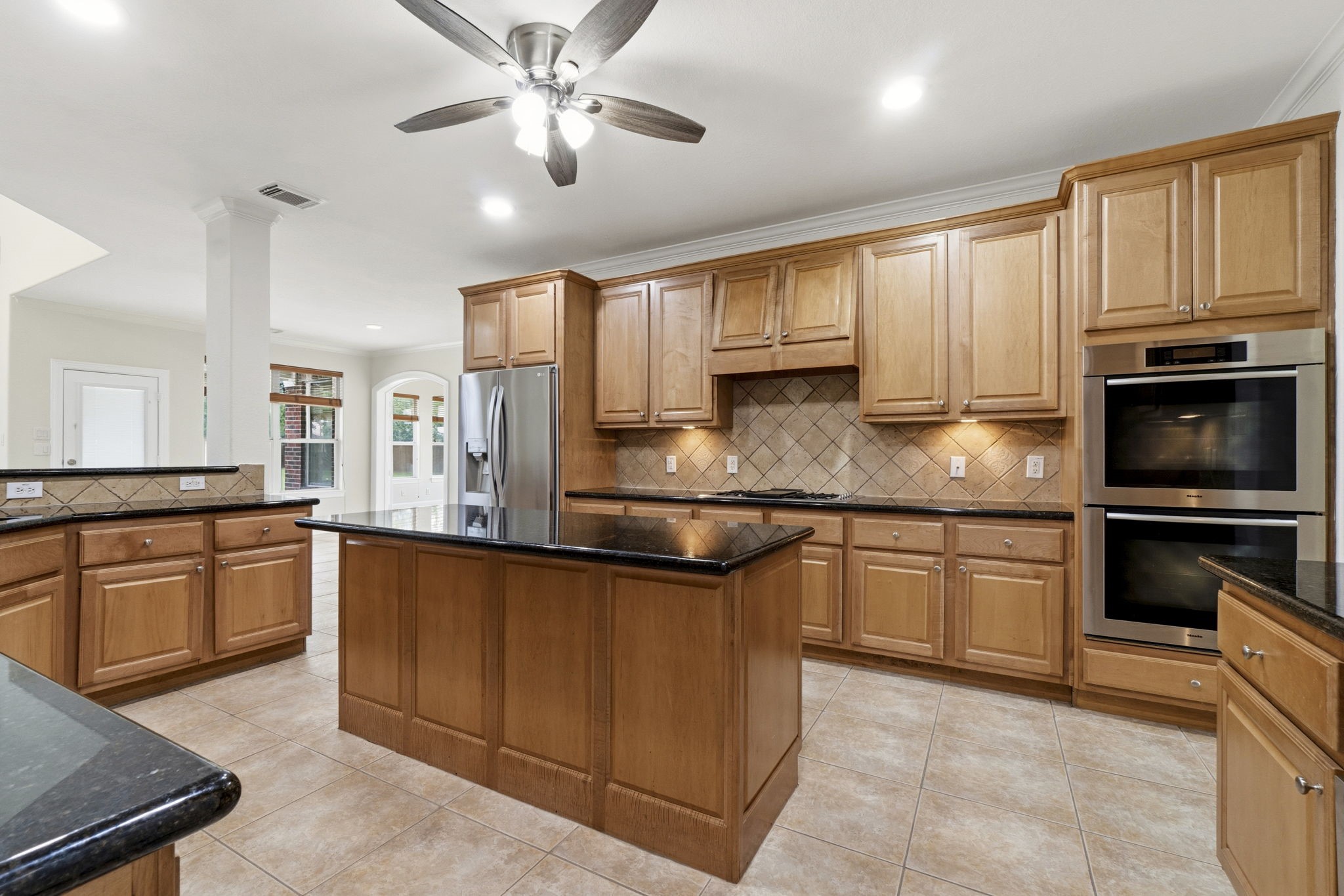 2716 Silverstone Way Conroe, TX 77304 - Photo 8 of 27 The kitchen boasts custom Kent Moore cabinetry, Fisher & Paykel cooktop, Miele double ovens, Bosch dishwasher, and other premium appliances.