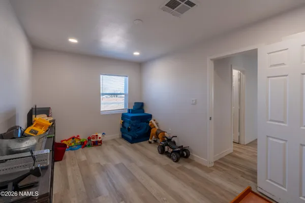 a view of room with toys and wooden floor