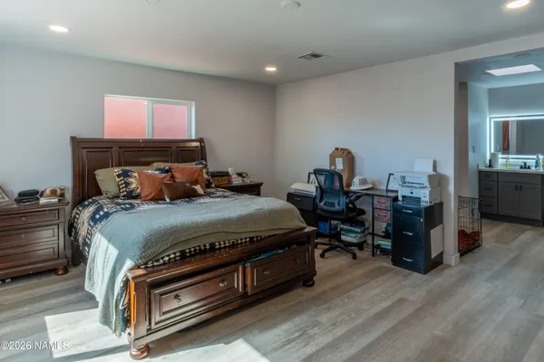 a bed room with a bed and a chair