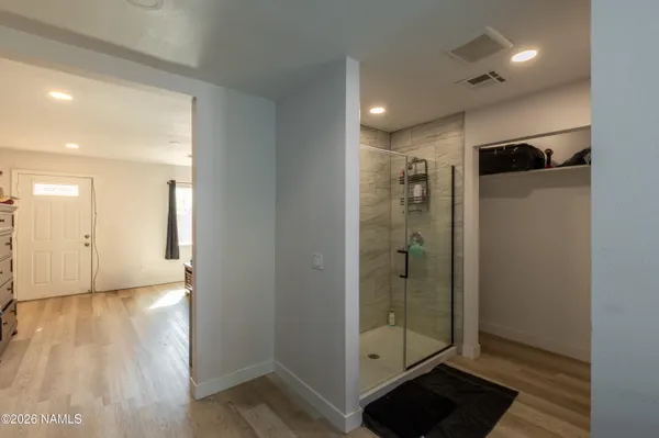 a view of a hallway with wooden floor