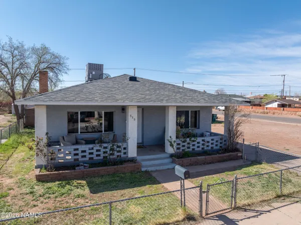a aerial view of a house with swimming pool and sitting area