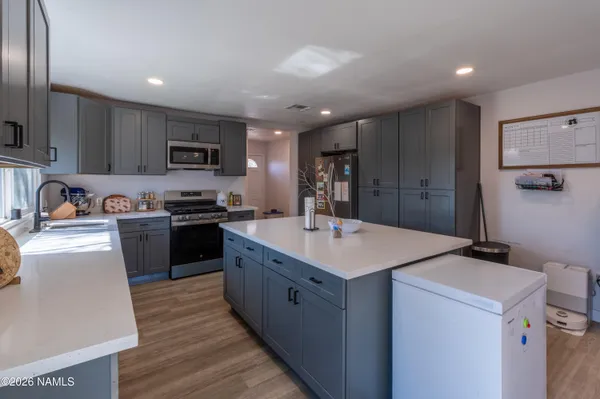a kitchen with a sink appliances and cabinets
