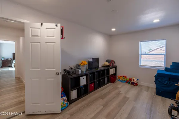 a view of a workspace with furniture and a window