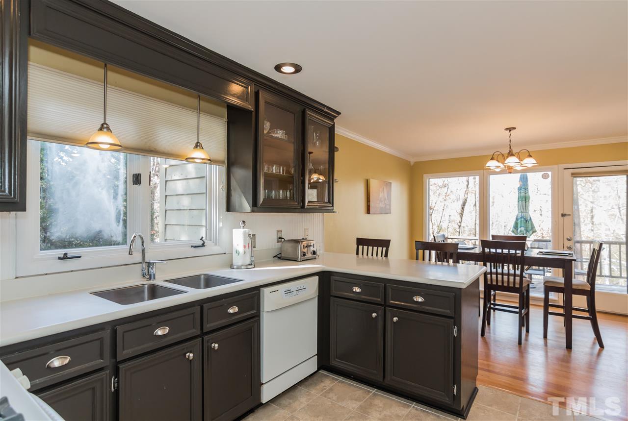 5 Sandstone Ridge Drive Durham, NC 27713 - Photo 12 of 25 a kitchen with lots of counter top space and dining table