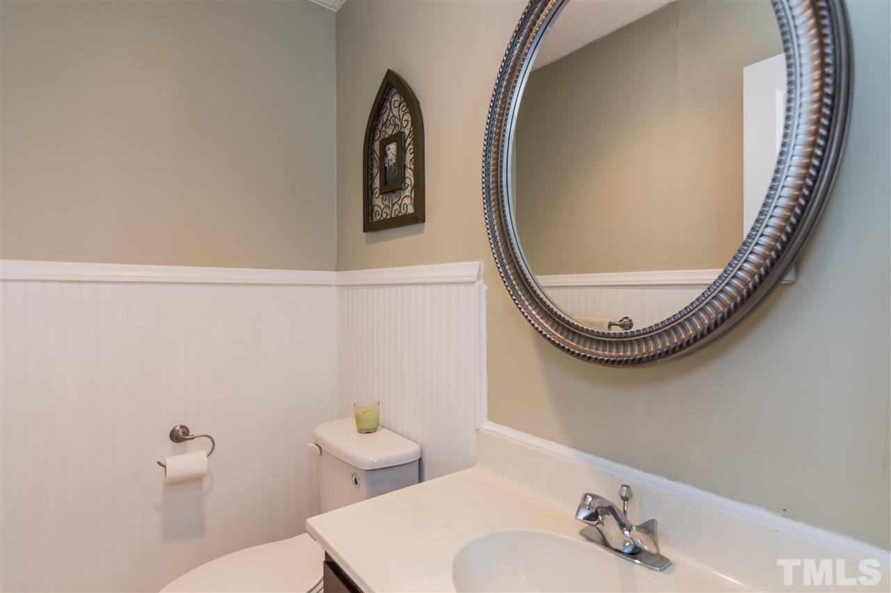 5 Sandstone Ridge Drive Durham, NC 27713 - Photo 15 of 25 a bathroom with a toilet and a mirror
