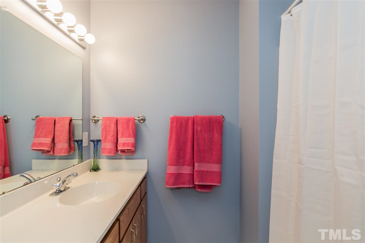 5 Sandstone Ridge Drive Durham, NC 27713 - Photo 17 of 25 a bathroom with a sink vanity and mirror