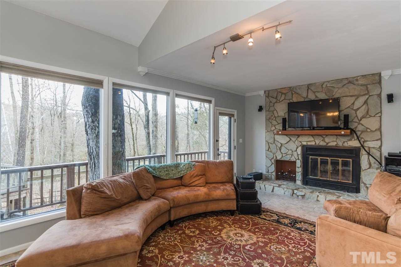 5 Sandstone Ridge Drive Durham, NC 27713 - Photo 3 of 25 a living room with furniture a large window and a fireplace