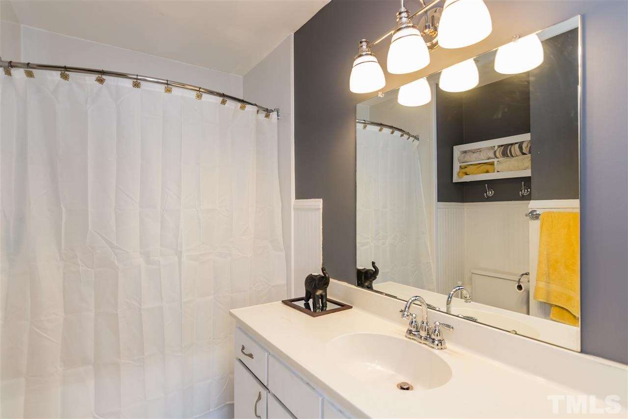 5 Sandstone Ridge Drive Durham, NC 27713 - Photo 21 of 25 a bathroom with a sink and a mirror