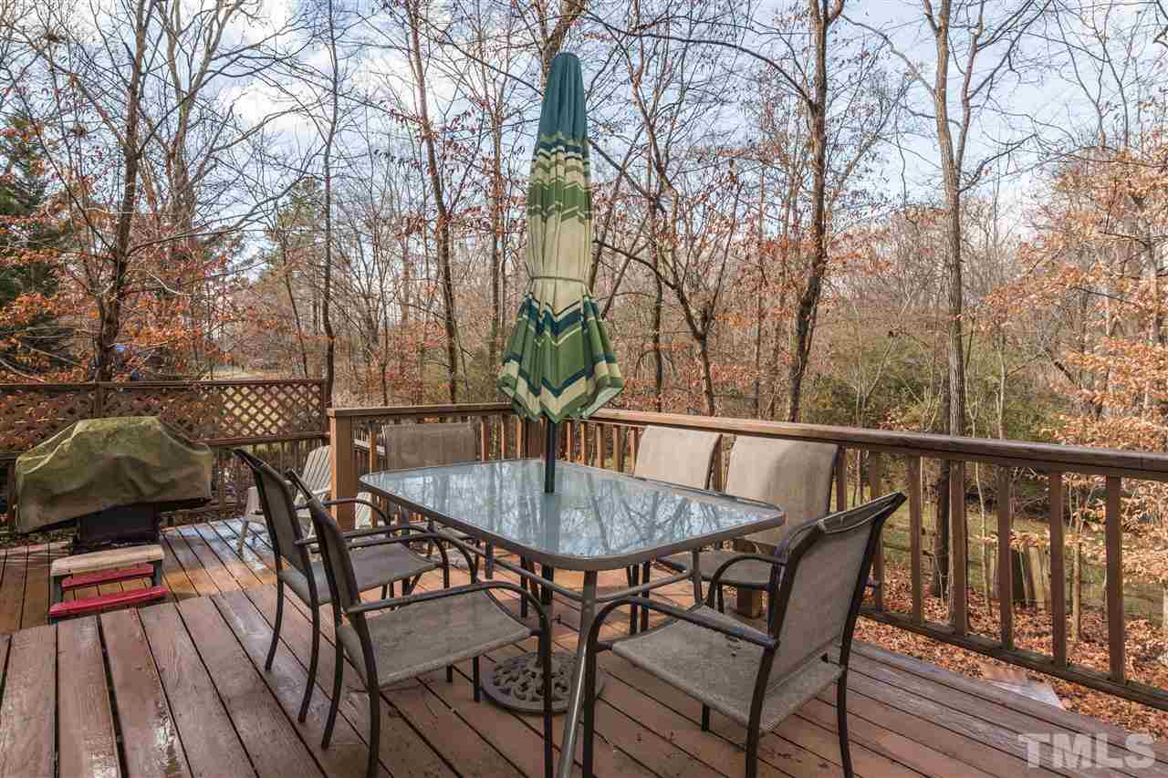 5 Sandstone Ridge Drive Durham, NC 27713 - Photo 22 of 25 a backyard of a house with table and chairs