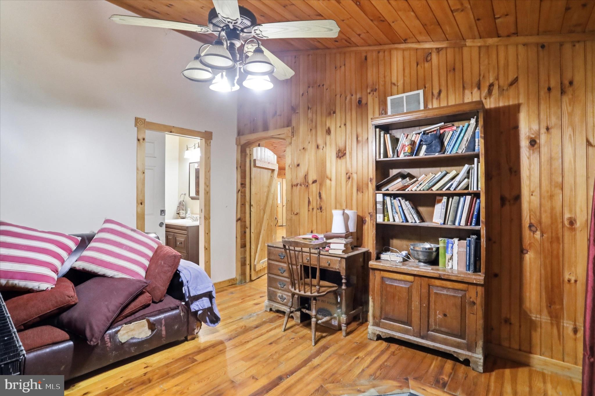 90 Shade Valley Road Rio, WV 26755 - Photo 14 of 41 a bedroom with furniture and a book shelf
