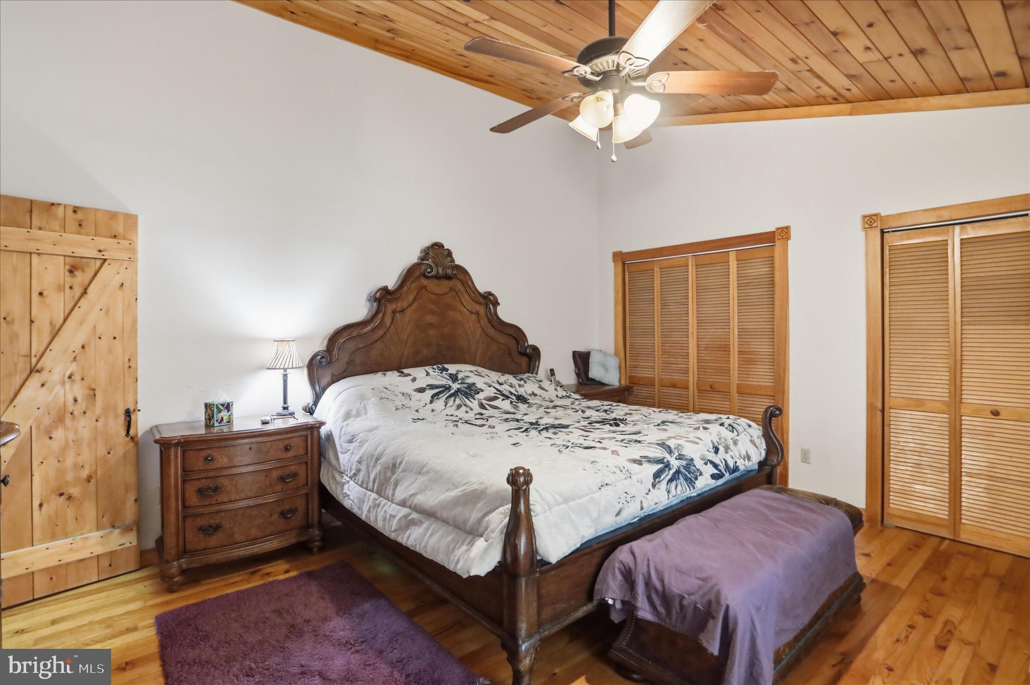 90 Shade Valley Road Rio, WV 26755 - Photo 23 of 41 a bedroom with a bed and a chandelier