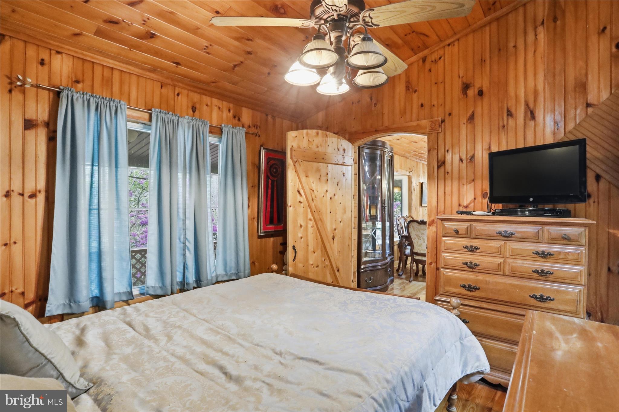 90 Shade Valley Road Rio, WV 26755 - Photo 26 of 41 a bedroom with a bed and a flat tv screen on dresser