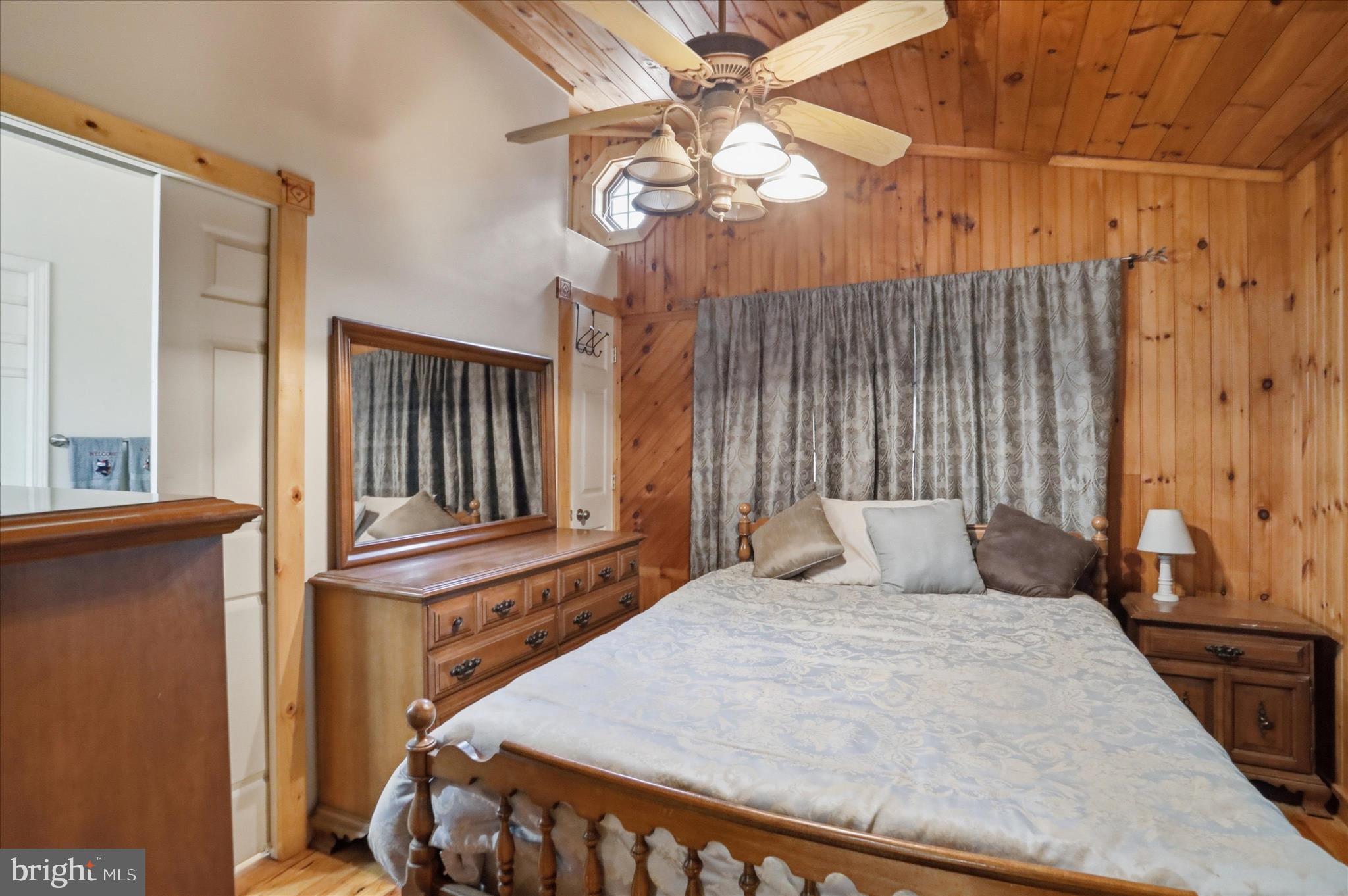 90 Shade Valley Road Rio, WV 26755 - Photo 28 of 41 a bedroom with a bed a window and a chandelier