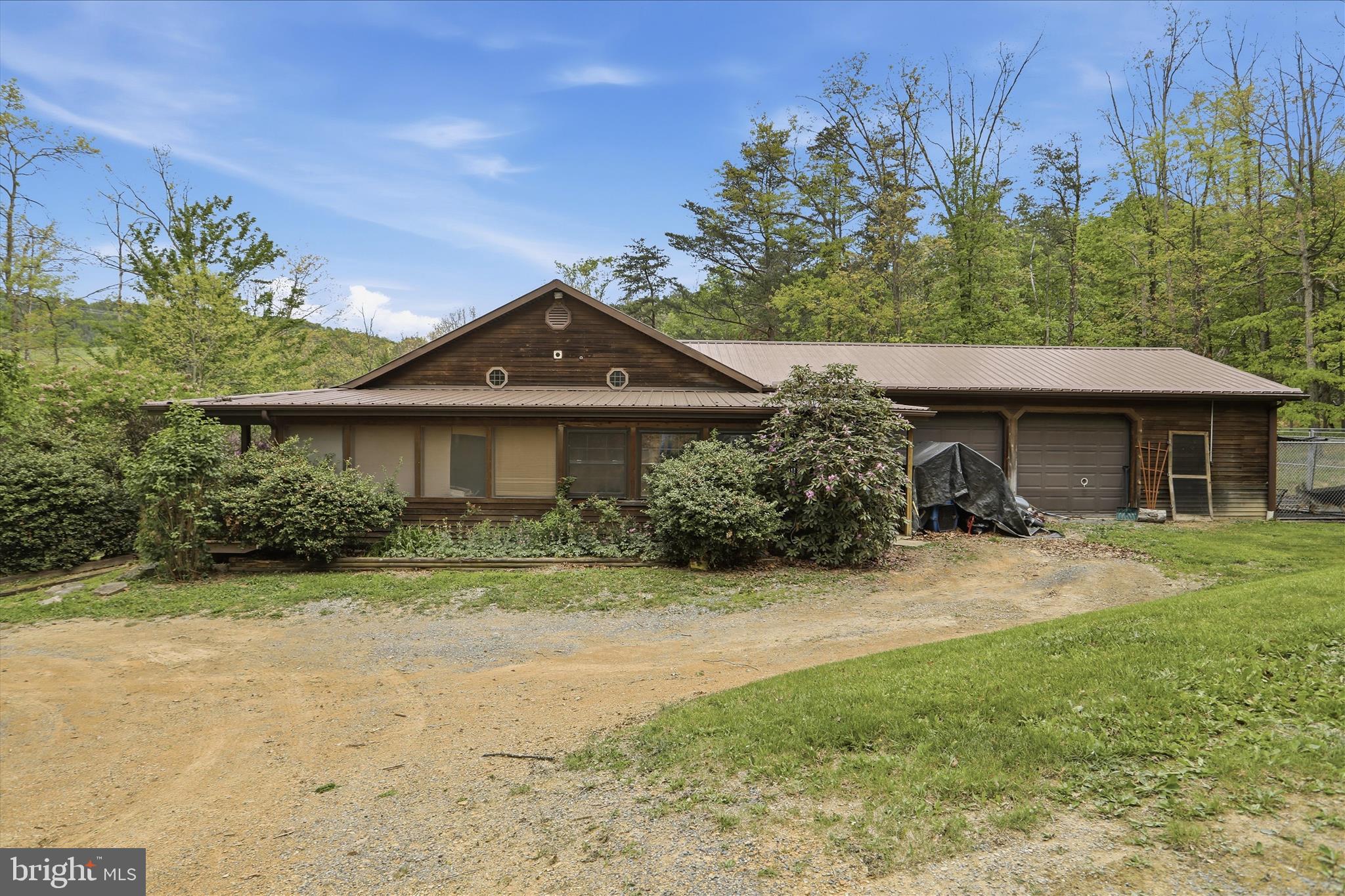 90 Shade Valley Road Rio, WV 26755 - Photo 4 of 41 a front view of a house with a garden