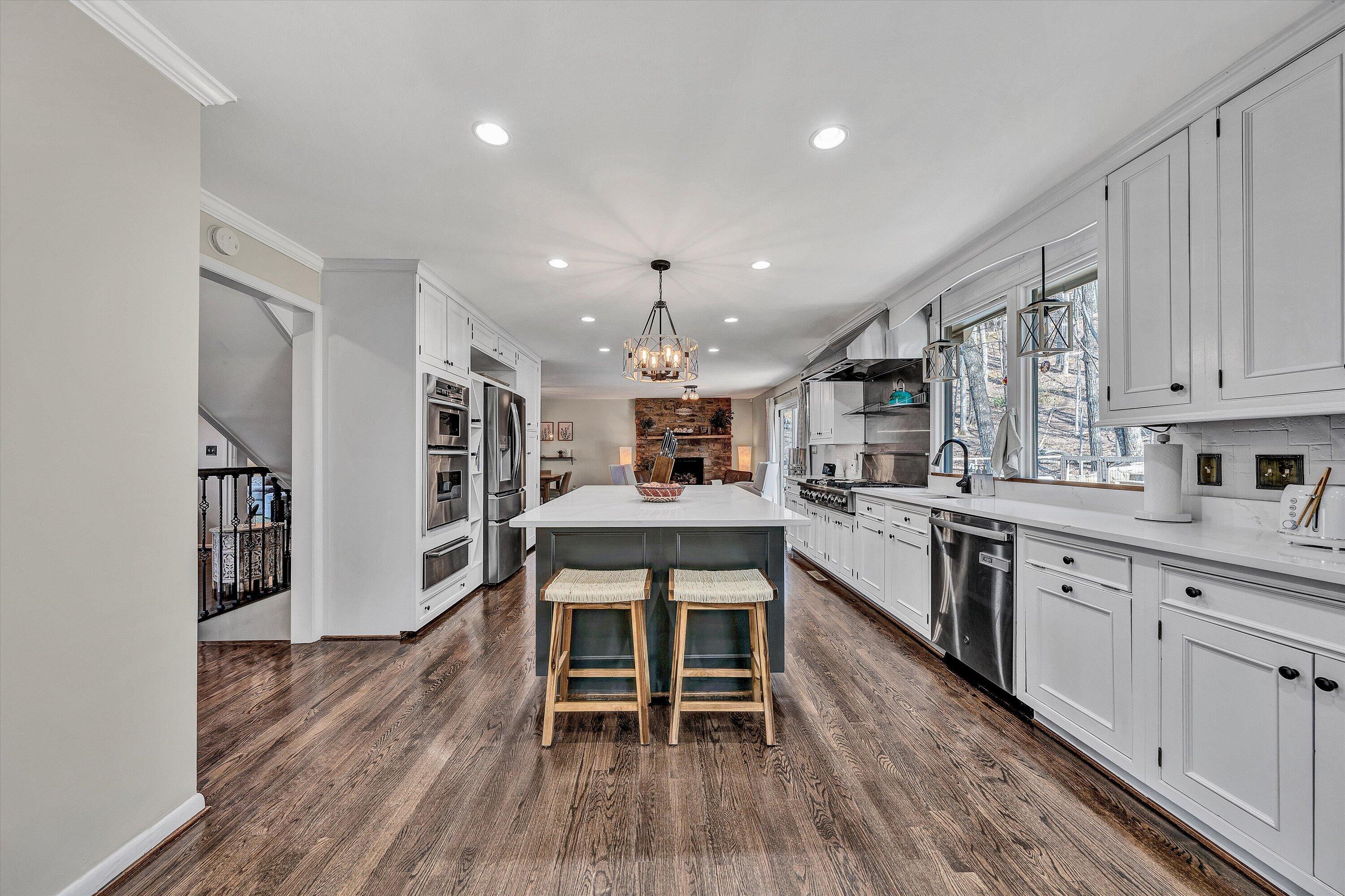 5157 Remington Road Roanoke, VA 24018 - Photo 17 of 63 a kitchen with a table chairs refrigerator and cabinets