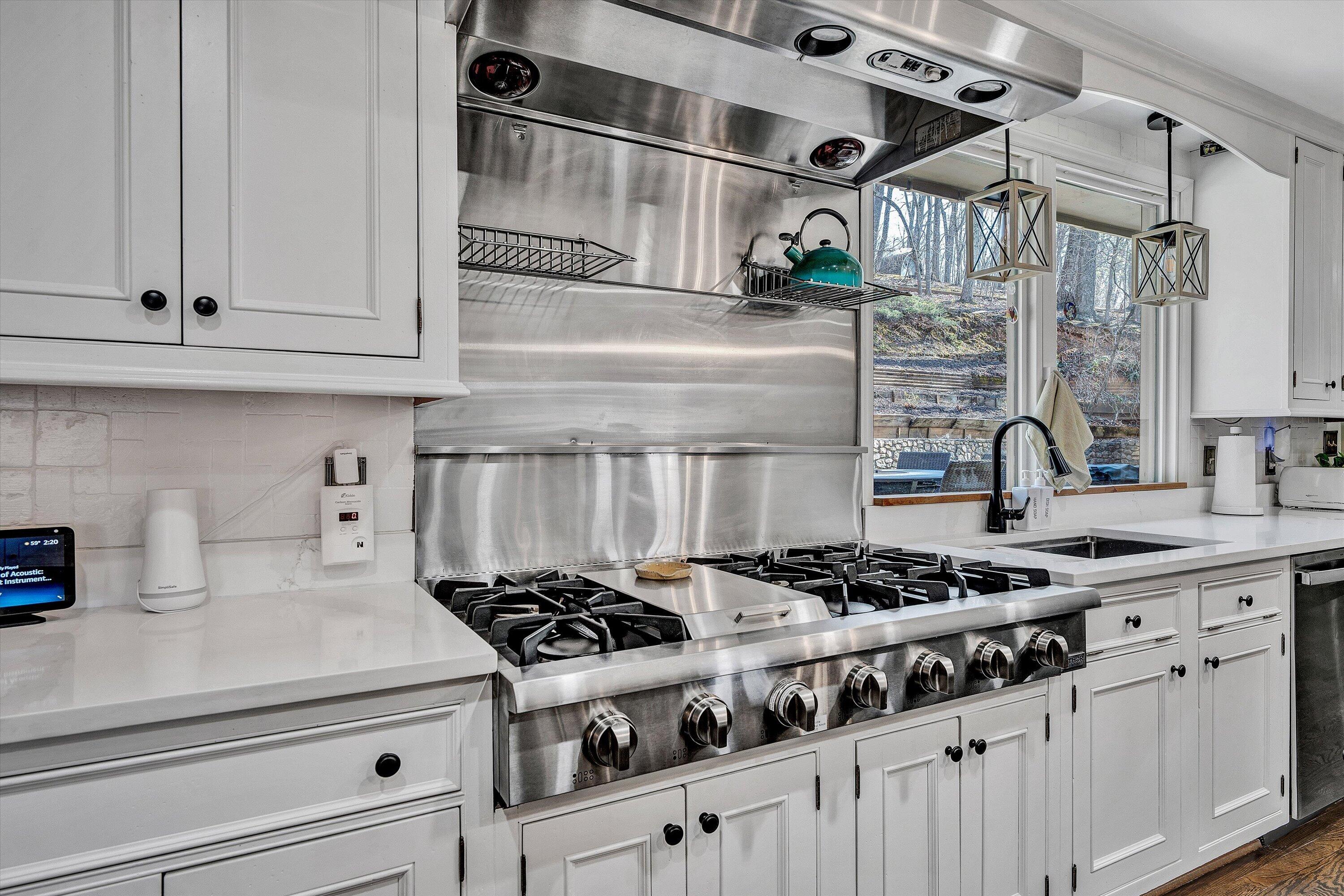 5157 Remington Road Roanoke, VA 24018 - Photo 21 of 63 a kitchen with a stove and white cabinets