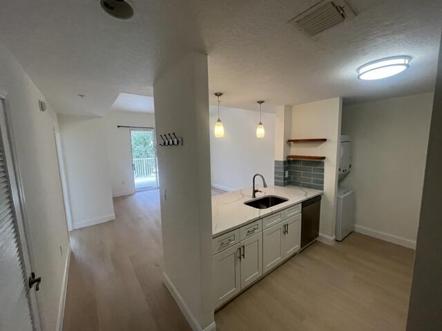 1155 Main Street, Unit 209 Jupiter, FL 33458 - Photo 6 of 10 a kitchen with a sink stove and cabinets
